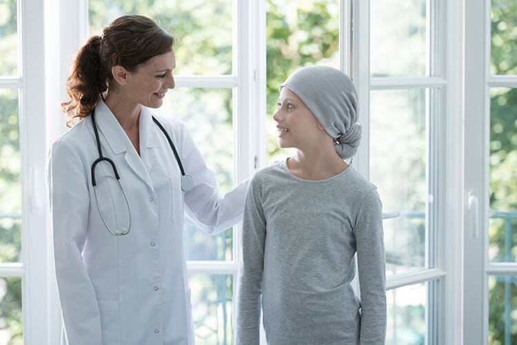provider speaks with child in hair scarf