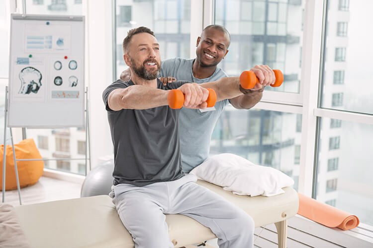 Physical therapist guides patient through a strengthening exercise